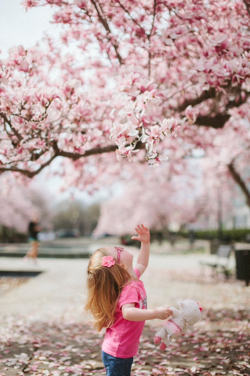 Photo by Karl Fredrickson girl under cherry blossom tree